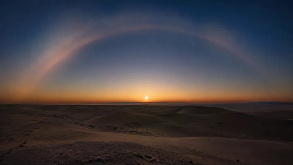 The bright blue-white star Sirius rising over a quiet desert horizon at dawn, symbolizing the Lion's Gate Portal 2026.